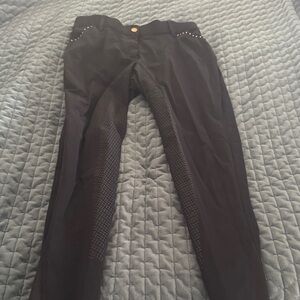 Black HKM breeches with rose gold accents.